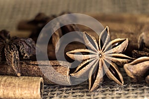 cinnamon sticks and star anise on burlap close-up. Photo. macro