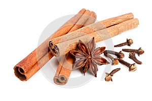 Cinnamon sticks with star anise and clove isolated on white background. Top view