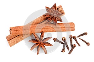 Cinnamon sticks with star anise and clove isolated on white background. Top view