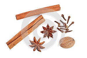 Cinnamon sticks with star anise, nutmeg and clove isolated on white background. Top view