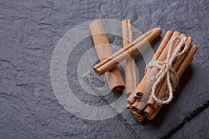 Cinnamon sticks on a stone background