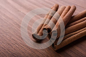 Cinnamon sticks on wooden background