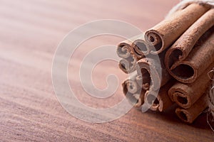 Cinnamon sticks on wooden background