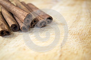 Cinnamon sticks on wooden background