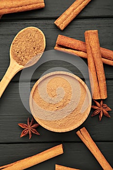 Cinnamon sticks on a wooden background. Cinnamon spice in bowl. Ceylon cinnamon. Vertical photo