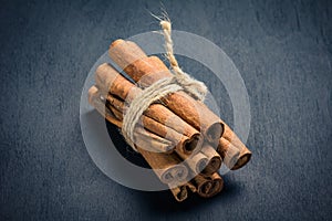 Cinnamon sticks on wooden background