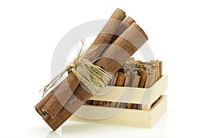 Cinnamon sticks wrapped together and a wooden crate.