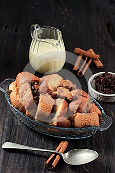 Cinnamon Vanilla Bread and Butter Pudding with Raisins in Clear Baking Dish, Served with Vla