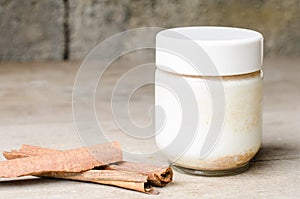 Cinnamon yogurt, rustic background.