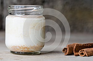 Cinnamon yogurt, rustic background.