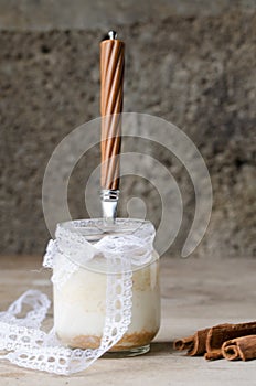 Cinnamon yogurt, rustic background.