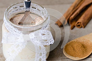 Cinnamon yogurt, rustic background.