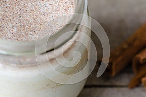 Cinnamon yogurt, rustic background.