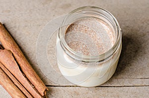 Cinnamon yogurt, rustic background.