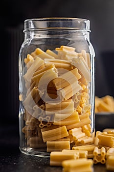 Cinque buchi. Uncooked italian pasta on black table