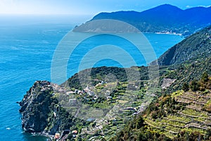 Cinque Terre coastal area around Corniglia Village as seen from the trail, the Cape Punta Mesco is at background. Liguria, Italy