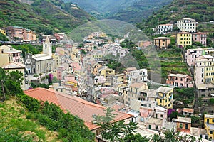 Cinque Terre, Italy - view of colorful houses, hills, vineyards of Riomaggiore, a seaside town on the Italian Riviera.