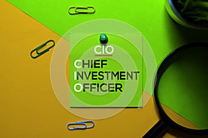 CIO. Chief Investment Officer acronym on sticky notes. Office desk background
