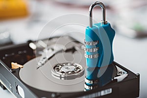 Cipher padlock on opened hard disk.