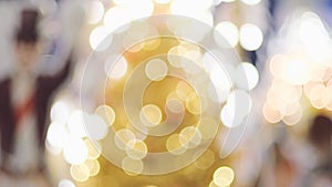 Circle bokeh light glowing on blurred golden Christmas trees , holiday background wallpaper concept