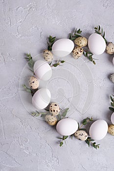 Circle border for easter card or invitation. Easter wreath with easter quail, chicken eggs and leaf sprigs of eucalyptus.