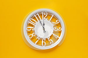 Circle clock on yellow background wall