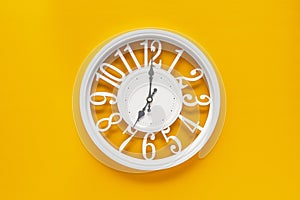 Circle clock on yellow background wall
