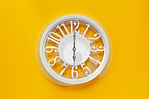 Circle clock on yellow background wall