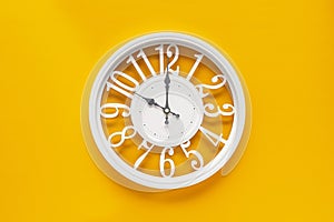 Circle clock on yellow background wall
