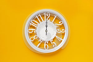 Circle clock on yellow background wall