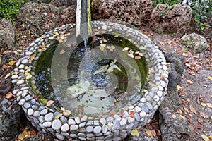 Circle decorative pond with pebble wall