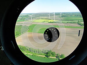 Circle glass in the wind Mill nacelle - view on wind park and a train