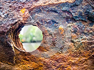 Circle hole on rusty surface.