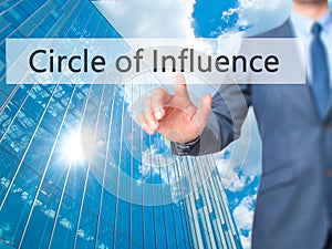 Circle of Influence - Businessman hand pressing button on touch