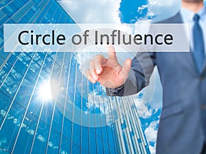 Circle of Influence - Businessman hand pressing button on touch photo