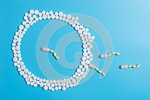 The circle is made up of white tablets on a blue background