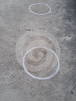 Circle markings at concrete to maintain social distancing