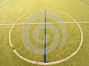 Circle in middle of court. Empty outdoor handball playground, plastic light green surface