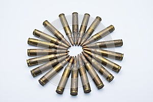 Circle of old rifle cartridges 5.56 mm on a white background