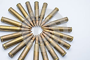Circle of old rifle cartridges 5.56 mm on a white background