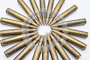 Circle of old rifle cartridges 5.56 mm on a white background