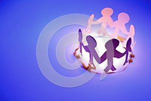 Circle of paper dolls on blue