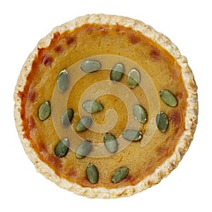 circle pumpkin pie decorated with green pumpkin seeds isolated on white
