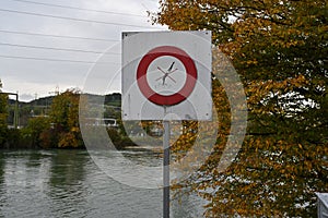 Circle red danger sign with pictogram, no jumping or no diving.