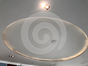 Circle or round gypsum false ceiling with coves with indirect lighting at center of an retail