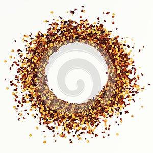 Circle shape frame of crushed red cayenne pepper, dried chili flakes and seeds isolated on a white background. Homemade spices