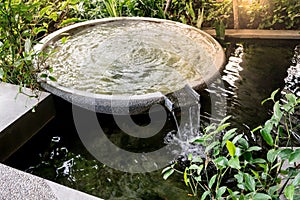 Circle shape water fountain and water fall in garden or park. photo