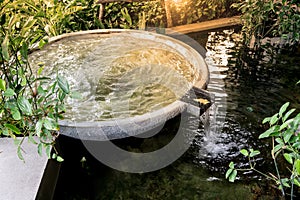 Circle shape water fountain and water fall in garden or park.