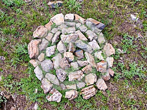 Circle of stones on ground, laid according to ancient culture to pacify spirit and humble person, selective focus photo