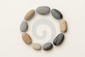 A circle of stones on a light background.